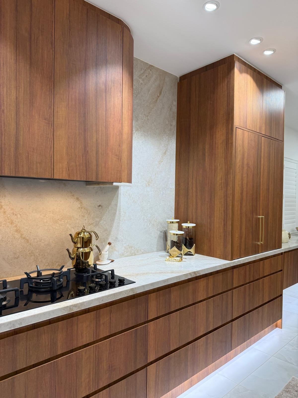 Timber kitchen cabinetry and pale stone finishes